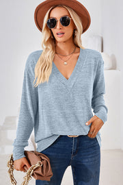 Relaxed light blue v-neck tunic top with long sleeves and a heathered texture.