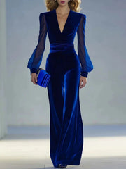 Royal blue velvet jumpsuit with sheer balloon sleeves and wide-leg pants.