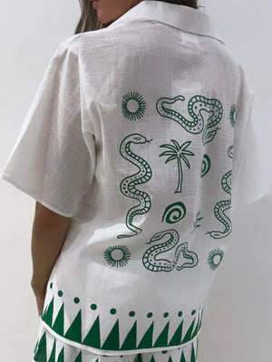 White linen co-ord set with green snake and palm tree print and geometric border