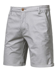 Gray chino shorts with elastic waist and button fly, cuffed hem.
