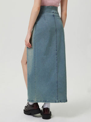 Denim maxi skirt in medium wash with a high slit front and button closure.