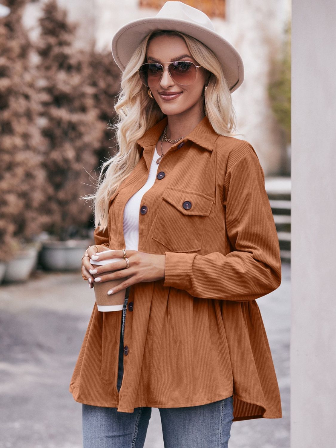 Ochre corduroy peplum shirt jacket with buttoned pockets and a flared hem.