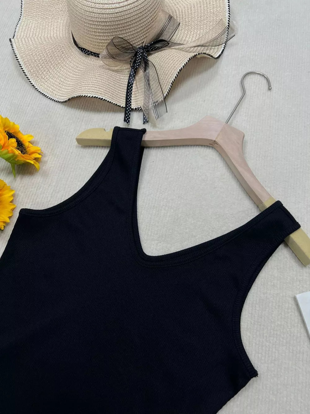 Black vertical ribbed V-neck tank top with a deep neckline.