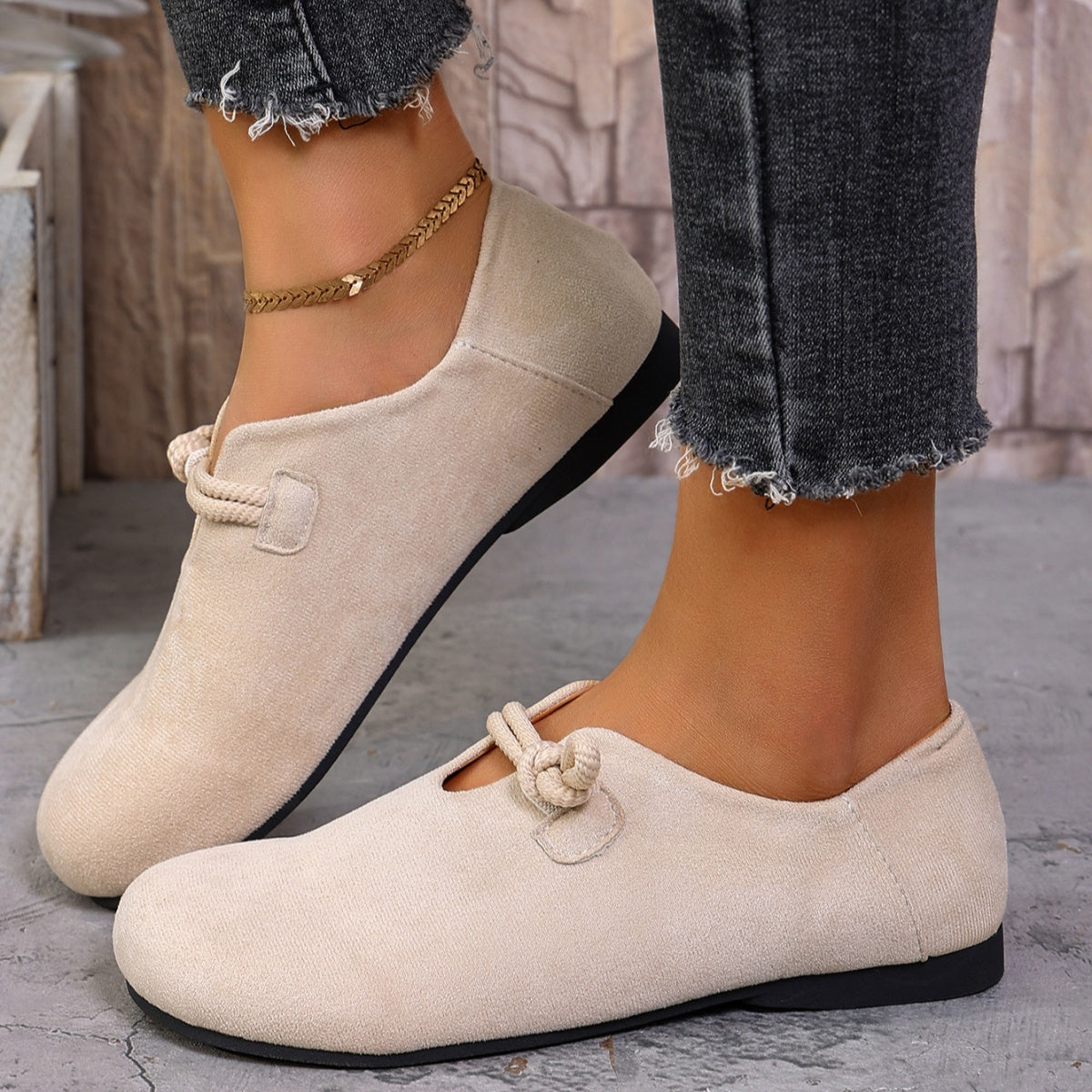 Beige matte fabric round toe flats with cord detail and a low heel.