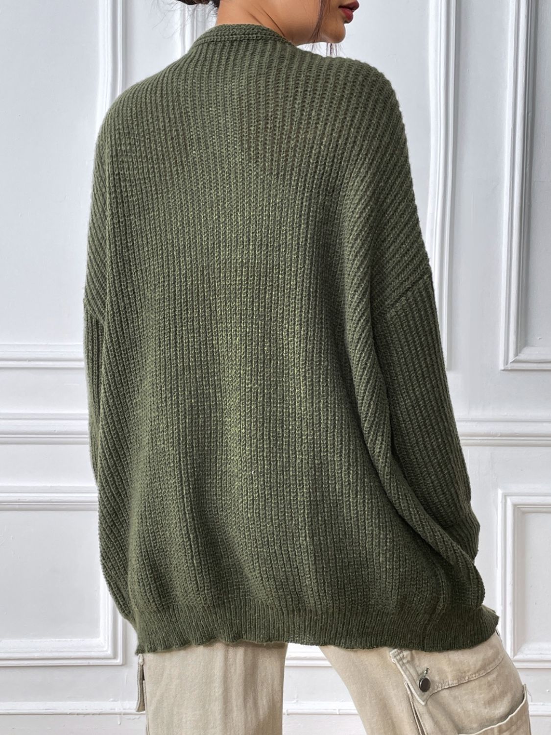 Olive green ribbed knit cardigan with balloon sleeves and a relaxed fit.