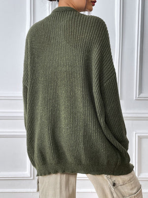 Olive green ribbed knit cardigan with balloon sleeves and a relaxed fit.