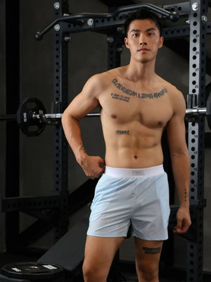 Light blue performance training shorts with white waistband and side pocket detail.