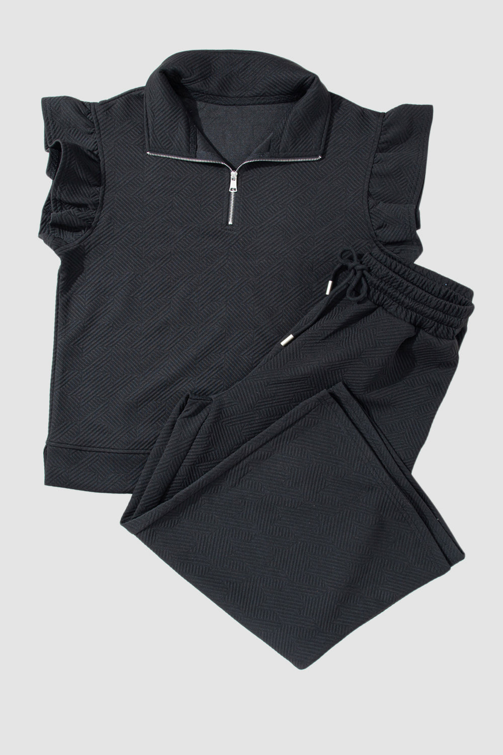 Black textured loungewear set with zip-up top and ruffle sleeves, and drawstring pants.