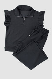 Black textured loungewear set with zip-up top and ruffle sleeves, and drawstring pants.