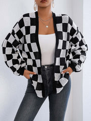 Checkerboard knit cardigan in black and white with balloon sleeves and open front.