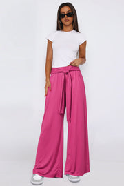 Hot Pink wide-leg flow pants with self-tie waist, styled with a white tee.