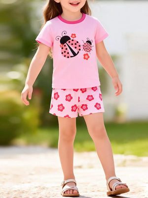 Pink short sleeve top and shorts set with ladybug and flower graphics.