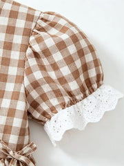 Brown gingham baby set with puff sleeves and eyelet lace trim.