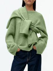 Oversized brushed knit crewneck sweater in Gum Leaf green with a sweater tied around the shoulders.