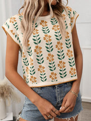 Floral knit sleeveless top in cream with orange flowers and green leaves pattern.