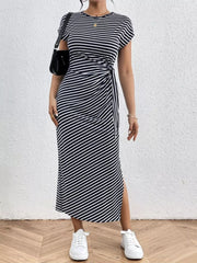 Black and white striped midi dress with tie-side detail and leg slit.