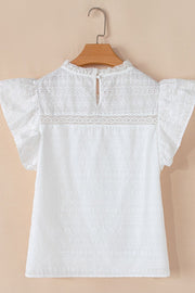 White eyelet yoke blouse with ruffle sleeves and a lace trim detail.