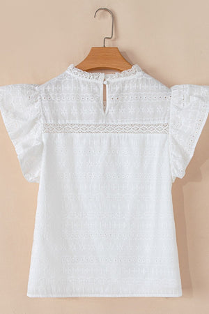 White eyelet yoke blouse with ruffle sleeves and a lace trim detail.
