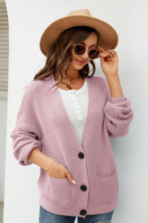 Blush pink textured knit cardigan with oversized pockets and button front