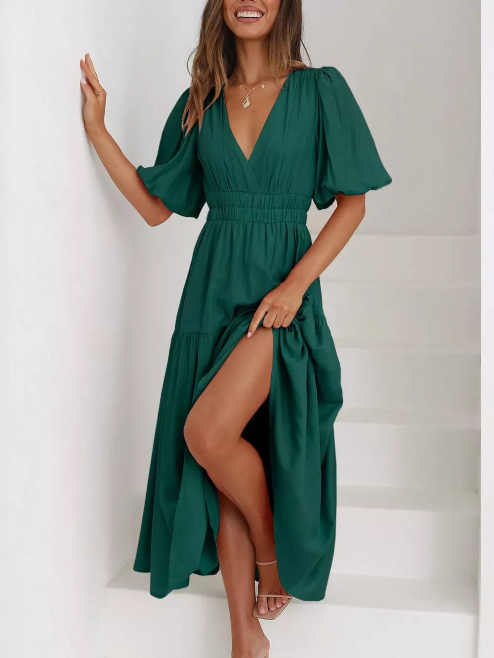 Green midi dress with V-neck, puff sleeves, cinched waist, and high slit.