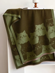 Reversible scarf in dark brown and green with a cute cat pattern.