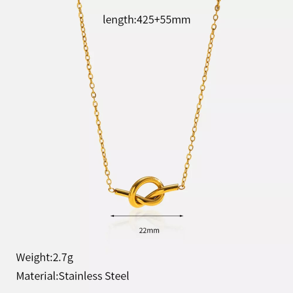 Gold-plated knot pendant necklace with delicate chain.
