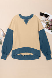 Chic Contrast Crewneck Sweatshirt in tan with blue sleeves and hem, featuring a V-stitch detail.