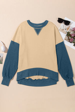 Chic Contrast Crewneck Sweatshirt in tan with blue sleeves and hem, featuring a V-stitch detail.