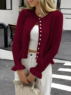 Burgundy knit cardigan with ruffled cuffs and button front.