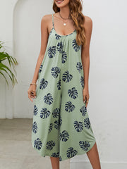 Sage green culotte jumpsuit with monstera print, gathered bust and spaghetti straps.