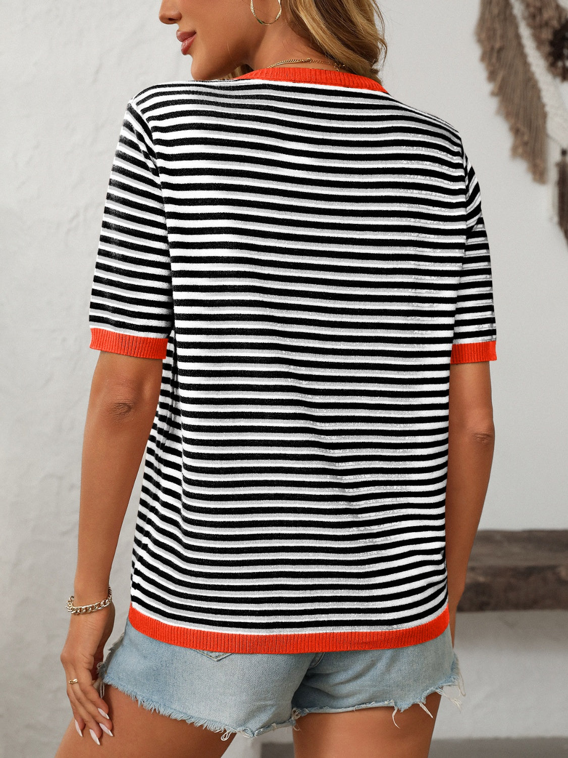 Retro stripe knit tee with contrast trim in black and red, featuring short sleeves and a crew neck.