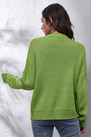 Yellow-green acrylic knit sweater with intarsia smiley flower pattern, crew neck, long sleeves, and ribbed cuffs and hem.
