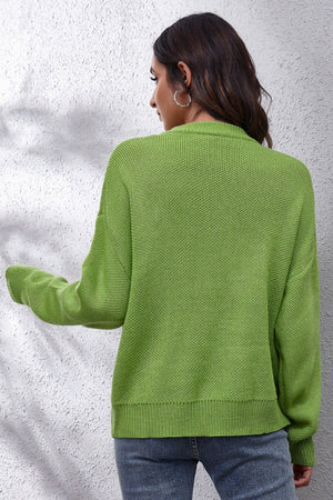 Yellow-green acrylic knit sweater with intarsia smiley flower pattern, crew neck, long sleeves, and ribbed cuffs and hem.