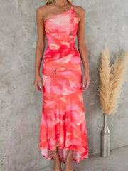 Floral one-shoulder maxi dress in red and pink with ruched detail and asymmetrical hem.