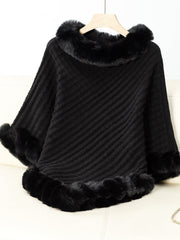 Black knit poncho with faux fur trim at neckline and cuffs