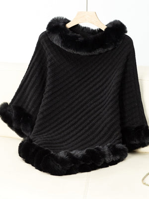 Black knit poncho with faux fur trim at neckline and cuffs