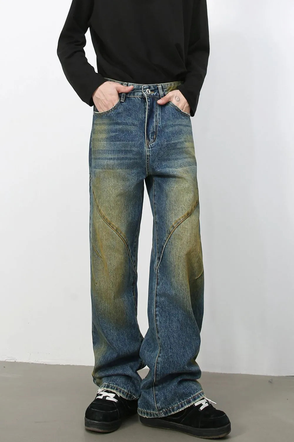 Panelled acid wash wide leg jeans in medium blue denim with yellowed accents.