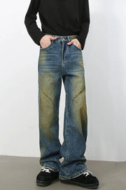 Panelled acid wash wide leg jeans in medium blue denim with yellowed accents.
