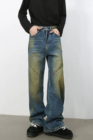 Panelled acid wash wide leg jeans in medium blue denim with yellowed accents.