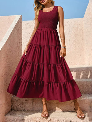 Burgundy smocked bodice ruffled maxi dress with tiered skirt and square neckline.
