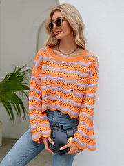 Orange-red crochet crop sweater with blue stripes, scalloped hem, and bell sleeves.