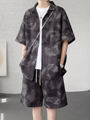 Men's dark gray camouflage short sleeve shirt and shorts set with textured fabric.
