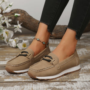 Khaki casual slip-on loafers with buckle detail and contrast stitching.