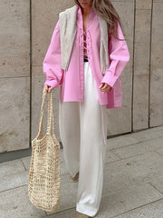 Pink cotton lace-up front relaxed fit shirt with long sleeves and a v-neck.
