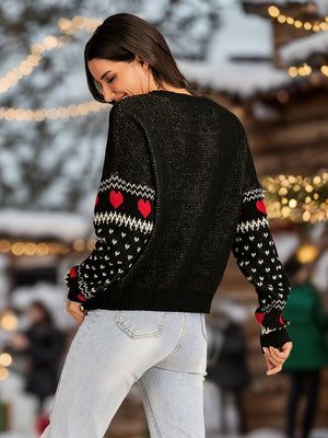 Black cotton sweater with round neck and red heart pattern on sleeves.