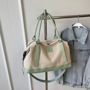 Canvas weekend holdall duffel bag in natural with mint green accents and strap.