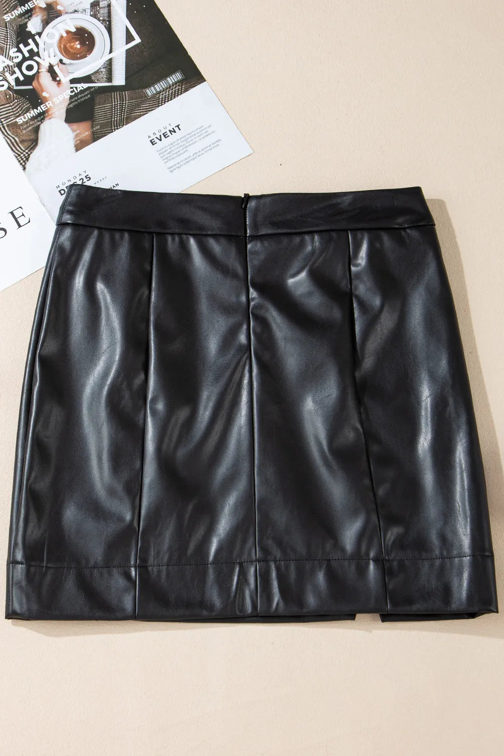 Black faux leather mini skirt with asymmetric slit and pleats