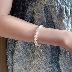 Pearl and green stone toggle bracelet with baroque pearls and gold accents.