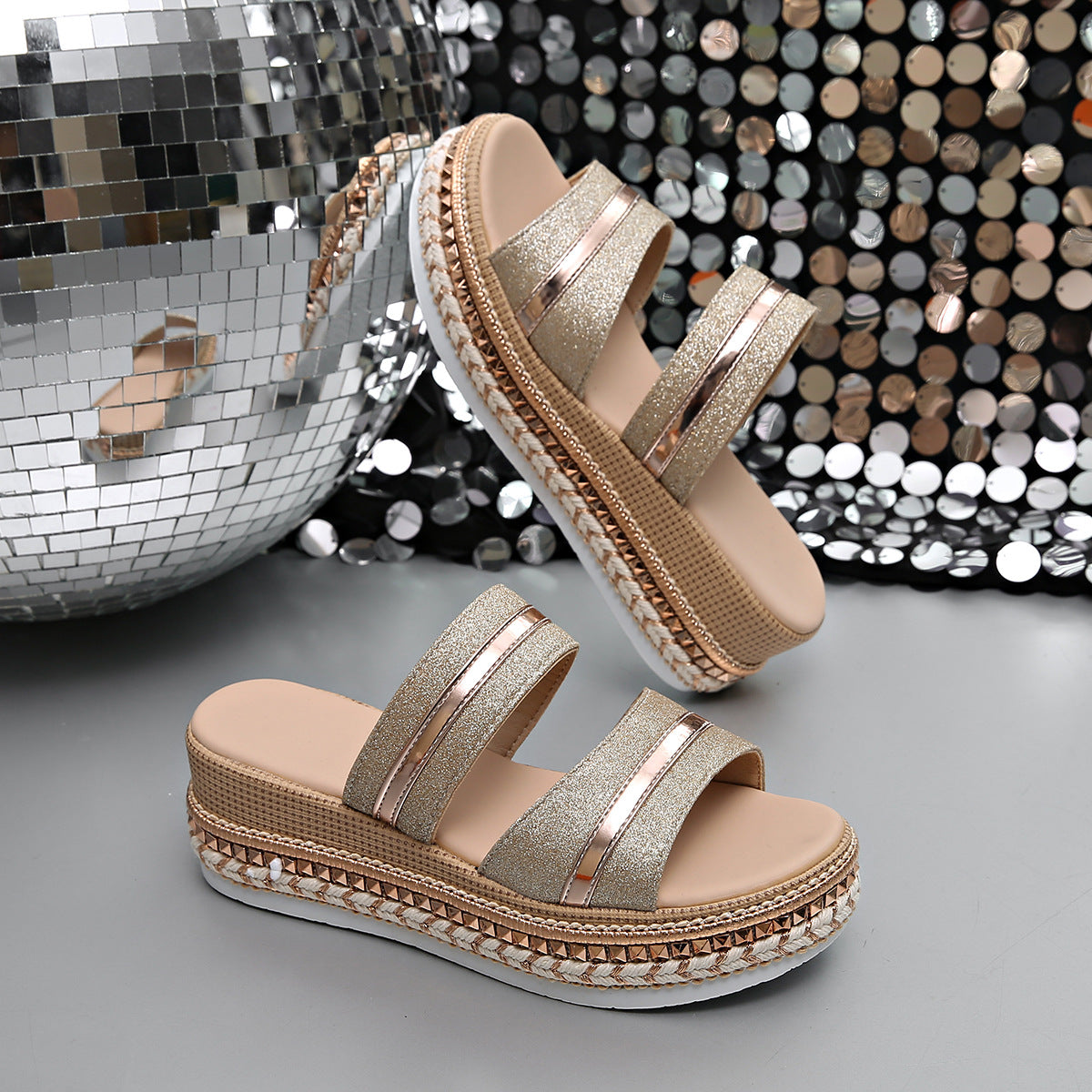 Glamorous wedge sandals with glitter straps and metallic accents, featuring a platform sole.
