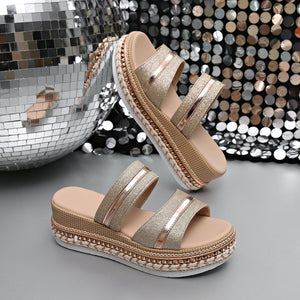 Glamorous wedge sandals with glitter straps and metallic accents, featuring a platform sole.